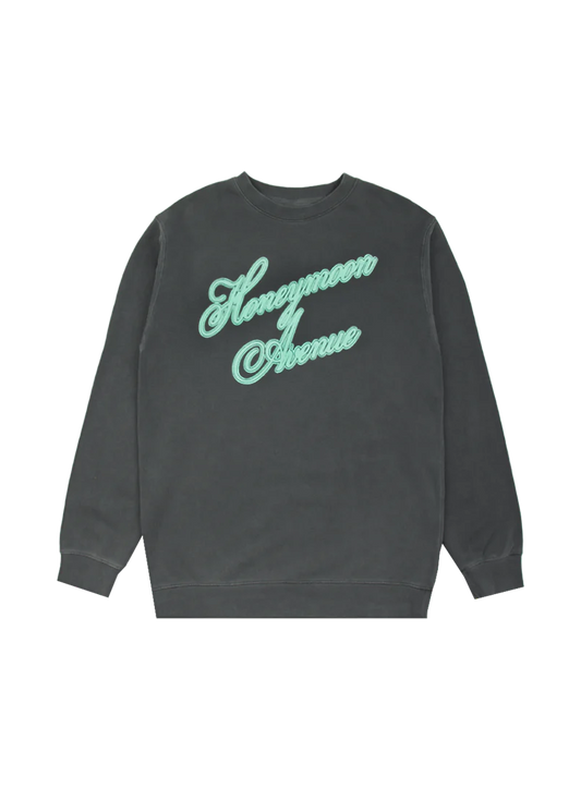Washed black crewneck sweatshirt featuring 'Honeymoon Avenue' in large mint green cursive embroidery across the chest. A cozy tribute to Ariana Grande's Yours Truly 10th Anniversary collection.
