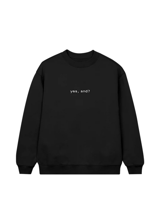 Black Ariana Grande crewneck sweatshirt with minimalist white text that reads “yes, and?” centered on the front — a statement piece from the official merch line.

